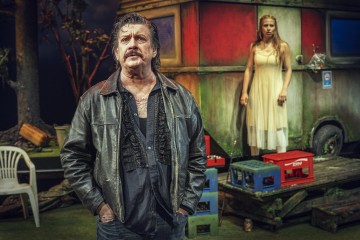 Nahkatakkinen mies seisoo valkoiseen mekkoon pukeutuneen naisen edessä, joka on puisella kuistilla vanhan, värikkään asuntovaunun vieressä. Kohtaus vaikuttaa dramaattiselta ja jännittyneeltä, ja se on lavastettu ulkoilmaan puiden ja muovituolien kanssa.